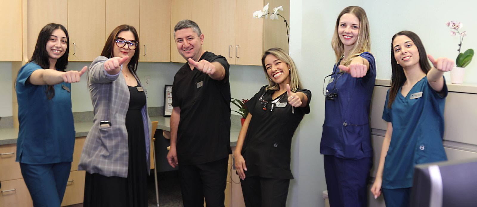The Lexington Family Dental team smiling together at the practice in Lexington, MA